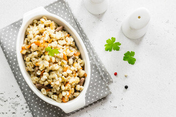 Barley porridge with vegetables and chicken. Top view, copy space, flat lay.