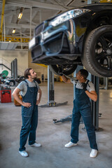 Fototapeta na wymiar Two maintenance engineers at work in the garage