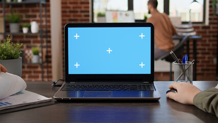 POV of startup manager typing on laptop with greenscreen in brick wall office. Using isolated...