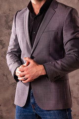 Elegant young handsome businessman in casual gray jacket close up