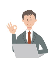 パソコン操作をするOKサインのビジネスマン