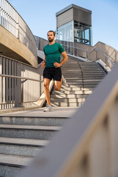Young man jogging on staircase