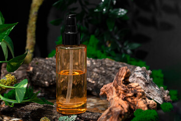 A bottle of sustainable skin care product and textured wood on a dark background. Eco cosmetics in a forest