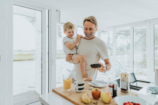 Happy father with son having breakfast at home