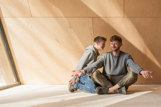 Father and son spending time together at wooden house
