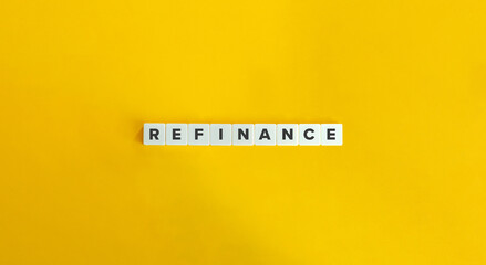 Refinance Word on Block Letter Tiles on Bright Orange Background. Minimal Aesthetics.