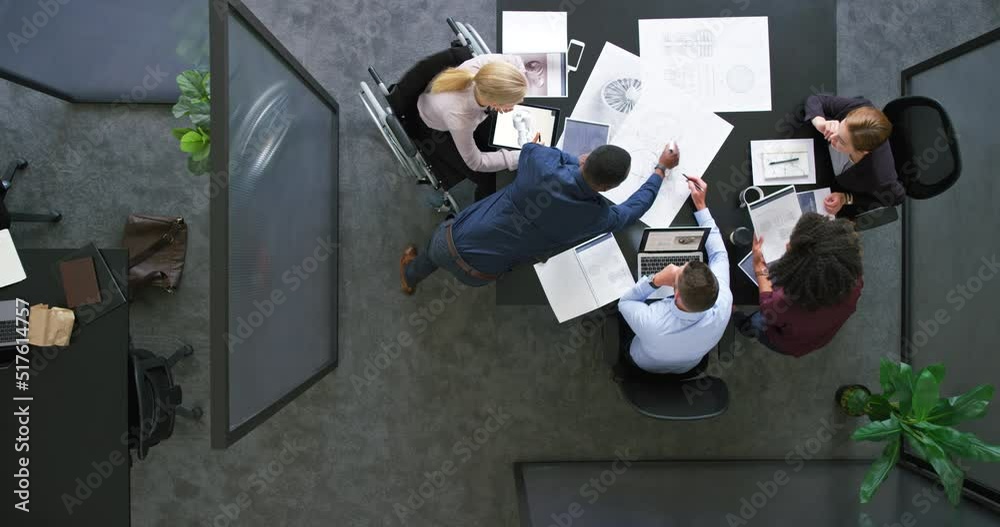Aufkleber A group of architects working together on a project or building design. Top view of a diverse team of business people brainstorming in a meeting. Colleagues planning and discussing at a company