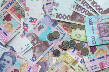 Ukraine money coins lying on  mixed hryvnia banknotes, background