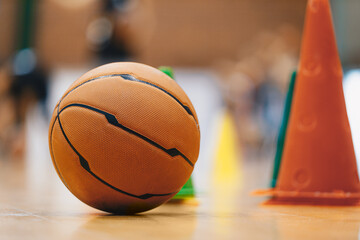 Basketball training equipment at training session. Basketball ball and training cones. Players at...