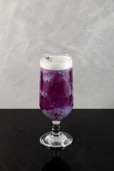 Purple ice tea with milk. Iced fruit cocktail. Refreshing summer drink