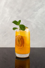 Peach and passion fruit cocktail with soda water. Refreshing summer drink. Iced fruit cocktail in...