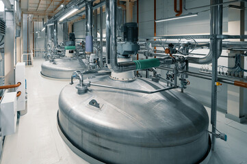 Large tank with processed aggressive liquids in workshop