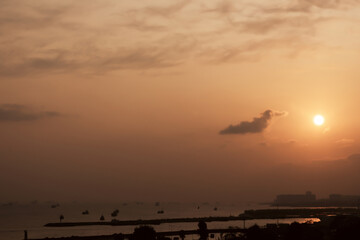 .Sunset on the sea coast in a little fog