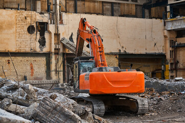 Hydraulic excavator works with debris at demolition site