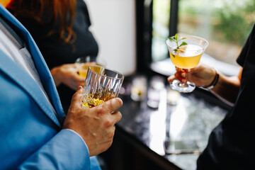 a company of people celebrating Friday in a bar