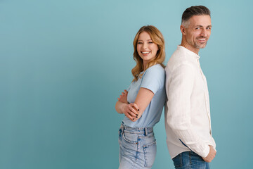 Fototapeta premium White happy man and woman smiling while standing back to back