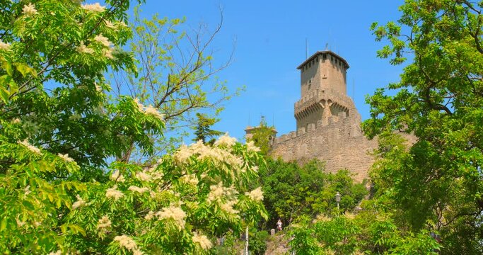 Low angle shot of Guaita fortress, which is the oldest of the three towers constructed on Monte Titano in San Marino, Italy at daytime. 4K.