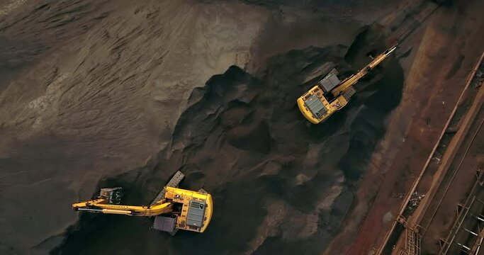 Top down View Of Excavators Working At Paradip Port Coal Storage In Odisha, India - drone shot
