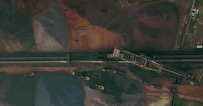 Overhead View Of Excavators Loading Trucks With Coal Near Stacker And Reclaimer. Aerial Shot