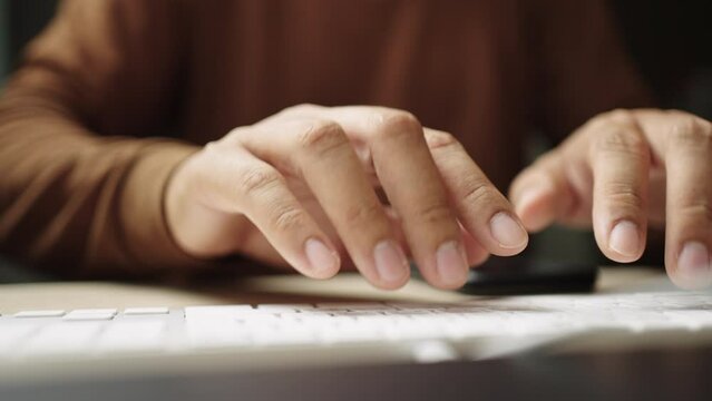 Close-up of Businessman hands typing on desktop computer keyboard for searching information, marketing research, 
online communication support and make a business report.