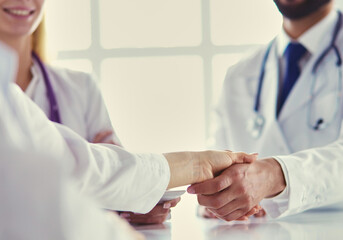 Doctor shaking hands with a male patient in the office