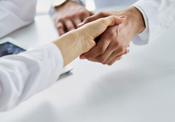 Team of doctors putting hands together, closeup