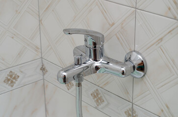 new hot and cold water faucet in bathroom wall