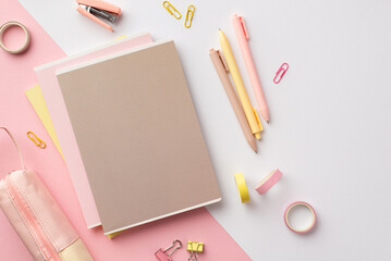 School accessories concept. Top view photo of pink and yellow stationery diaries pens mini stapler binder clips adhesive tape and pencil-case on bicolor pink and white background