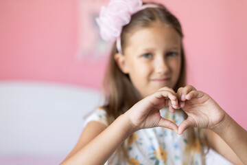 Girl showing a heart