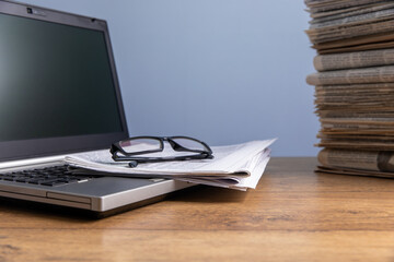 newspapers and glasses on notebook