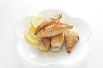 Chinese food, pan fried chicken wings served with lemon for comfort food image