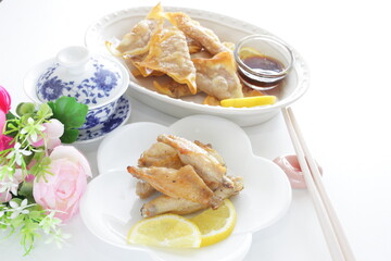 Chinese food, grilled chicken wings and tea with fried wanton
