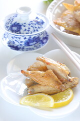 Chinese food, grilled chicken wings and tea with fried wanton