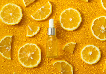 Bottle of cosmetics and drops of liquid, moisturizing lemon. Hyaluronic acid. Selective focus.
