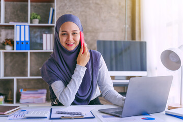 Young muslim woman working in business office, wearing Hijab works as start up SMEs project....