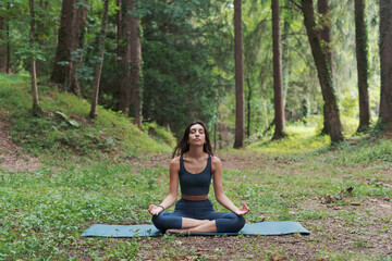 Woman practicing meditation in the forest