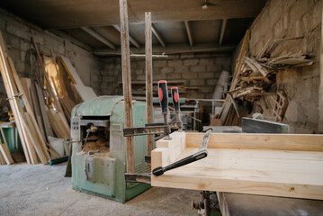 Clamps in the workshop.Clamped pieces of wood with c-clamps and bar clamp , wooden parts in the carpentry workshop