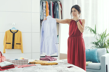 Woman choosing clothes in her bedroom