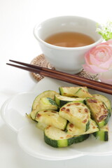 Chinese food, pan fried zucchini on white dish for vegetarian food image