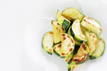 Chinese food, pan fried zucchini on white dish for vegetarian food image