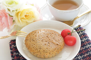 Homemade brown sugar cake and cherry served with English tea