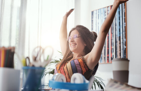 Cheerful woman sitting at desk