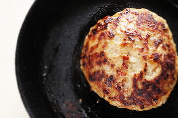Homemade hamburger patty on skillet pan for comfort food image