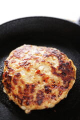 Homemade hamburger patty on skillet pan for comfort food image