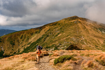 Obraz premium Adventure lifestyle, travel in the mountains with a backpack and overnight.