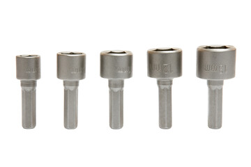 Set of interchangeable hexagonal sockets of different shapes and sizes for screwdriver or nut driver with isolated on white background, clipping path. Selective focus.