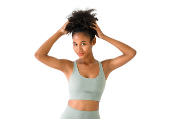 Fototapeta na wymiar Beautiful young African American girl posing with fitness clothes isolated over white background. Healthy and Fitness concept.