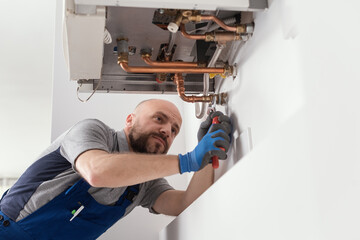 Professional engineer installing a boiler