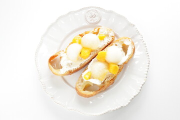 Homemade fruit and cream cheese French bread open sandwiches, white melon and mango