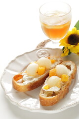 Homemade fruit and cream cheese French bread open sandwiches, white melon and mango